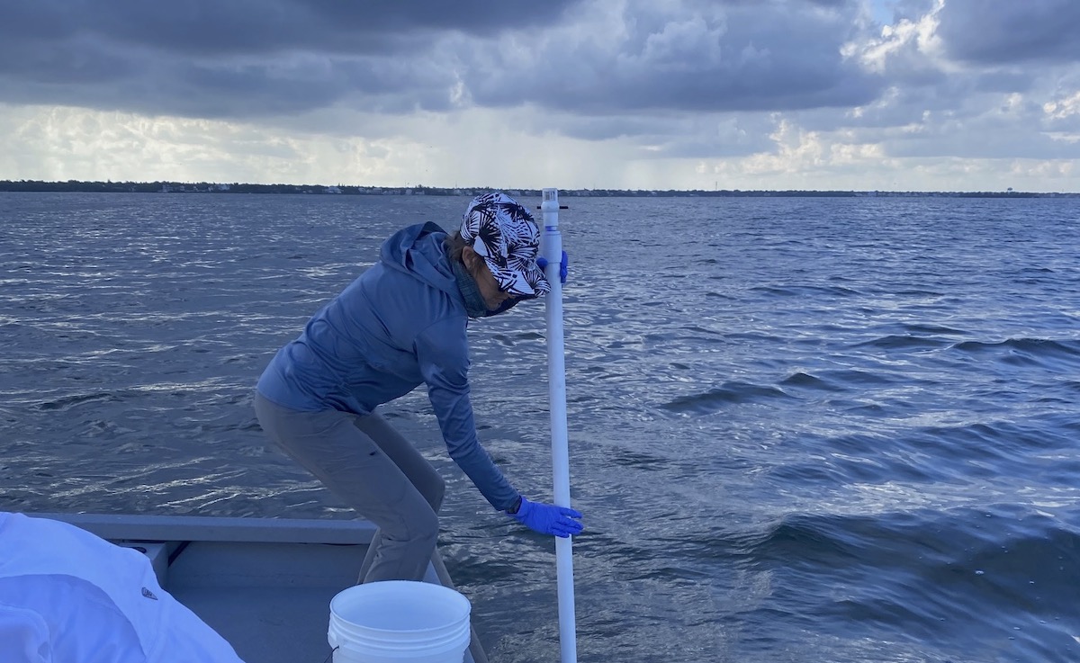 Researchers test ocean water on a boat